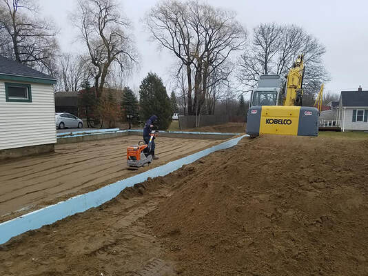 Doug Fales crew leveling land for foundation preparation