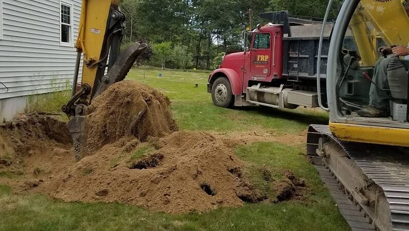 Excavator digging in yard